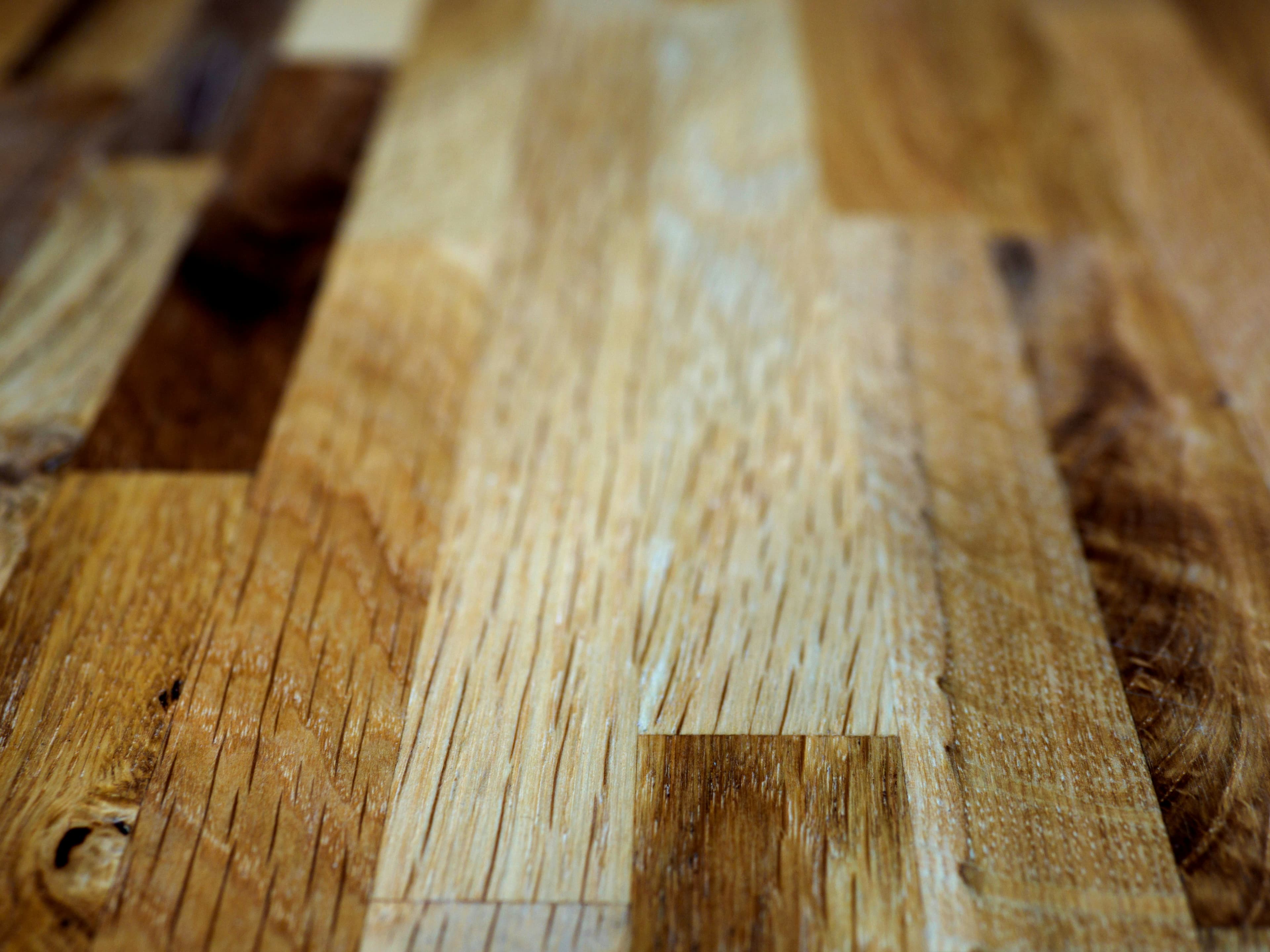 Close-up detail of a professionally refinished hardwood floor showing natural grain.